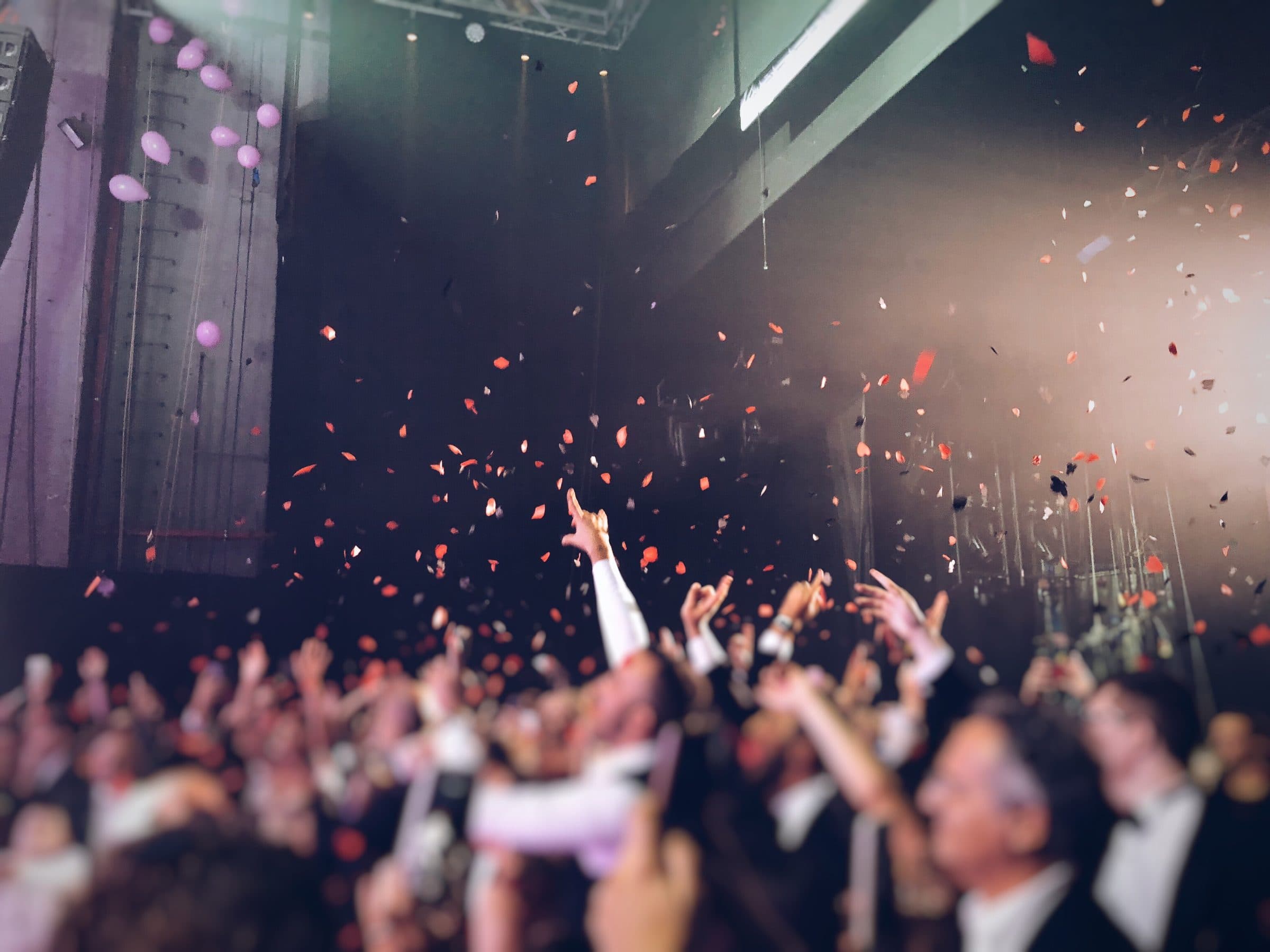 Audience celebrating under confetti at an event